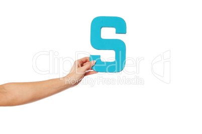 hand holding up the letter S from the left