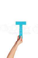 hand holding up the letter T from the bottom
