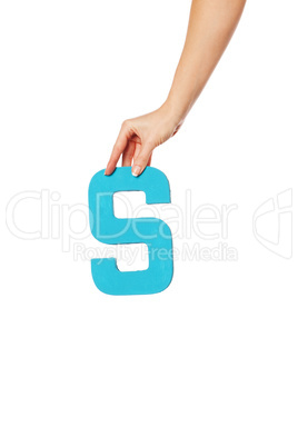hand holding up the letter S from the top