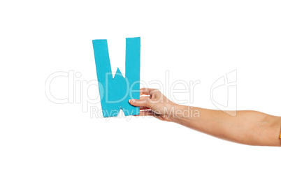 hand holding up the letter W from the right