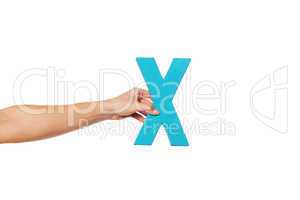 hand holding up the letter X from the left