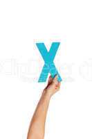 hand holding up the letter X from the bottom