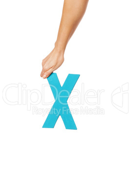 hand holding up the letter X from the top