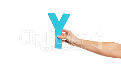 hand holding up the letter Y from the right