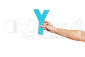 hand holding up the letter Y from the right