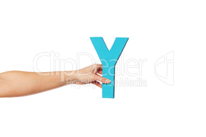 hand holding up the letter Y from the left