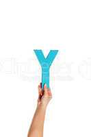 hand holding up the letter Y from the bottom