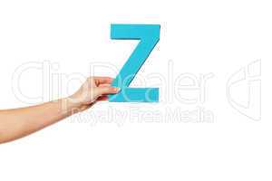 hand holding up the letter Z from the left