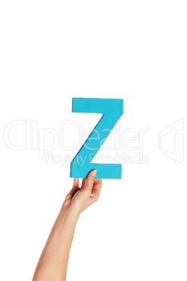 hand holding up the letter Z from the bottom