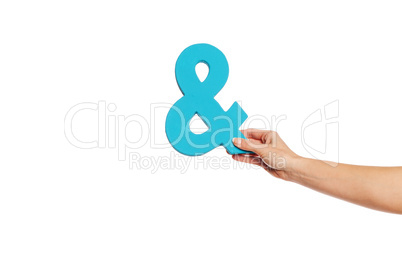 hand holding up an ampersand from the right