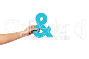 hand holding up an ampersand from the left