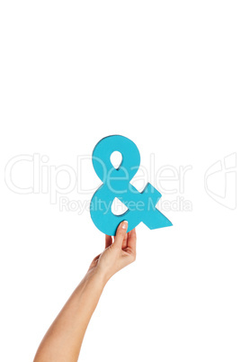 hand holding up an ampersand from the bottom