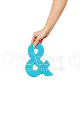 hand holding up an ampersand from the top