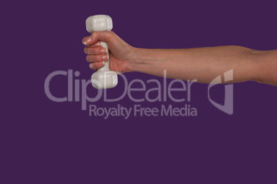 Female hand holding a small dumbbell