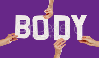 Female hands holding letters BODY