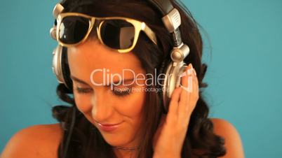 Brunette disc jockey listening to music
