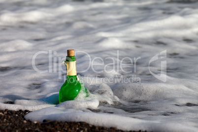 Bottle of wine in sea surf