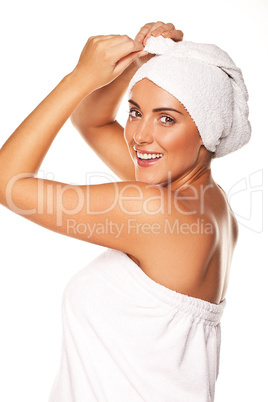 Beautiful woman tying up her wet hair