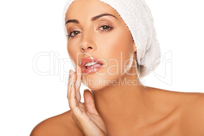 Beautiful woman applying lip gloss