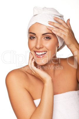 Vivacious woman wrapped in a white towel