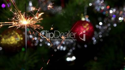 Christmas tree, mirror ball and lit sparkler