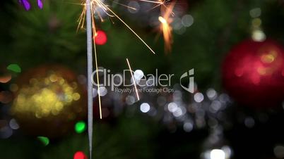 Christmas tree, mirror ball and lit sparkler