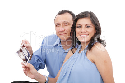 Attractive hispanic young pregnant couple expecting a child hold