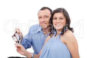 Attractive hispanic young pregnant couple expecting a child hold