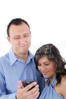 Couple looking at a cell phone and smiling isolated on a white b