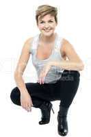 Charming woman in squatting posture
