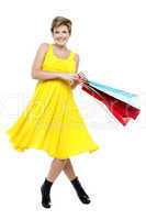 Portrait of beautiful young woman carrying shopping bags