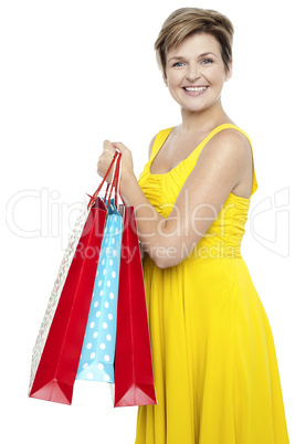 Pretty woman holding colorful shopping bags