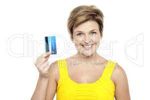 Cheerful woman holding up her cash card