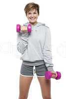 Sporty middle aged woman with dumbbells