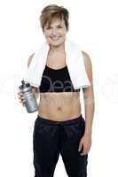 Charming fit lady holding up a bottle of water