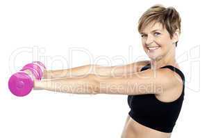 Young beautiful woman with dumbbells in hands