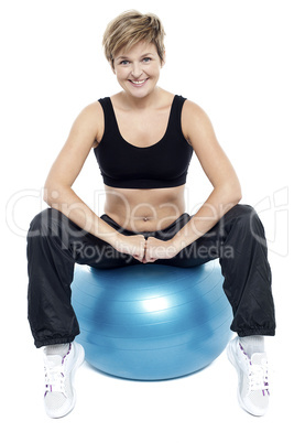 Fitness woman relaxing on exercise ball