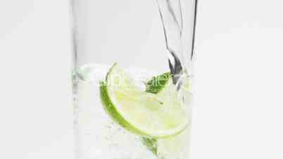 Ice Cubes, Lime and Water in a Glass, Slow Motion