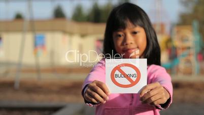 Girl Holding A NO BULLYING Sign
