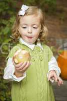 Adorable Child Girl Eating Red Apple Outside