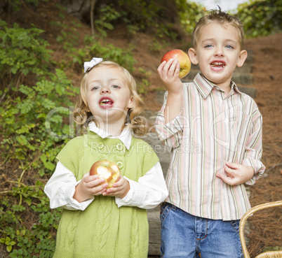 Adorable Children Eating Red Apples Outside