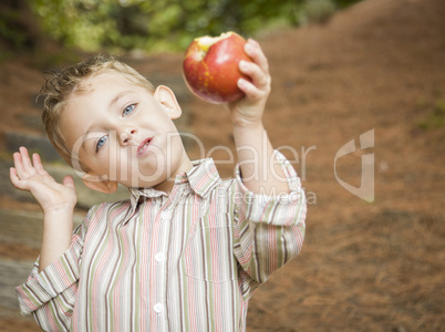 Adorable Child Boy Eating Red Apple Outside