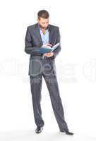 Full length portrait of thoughtful business man with diary