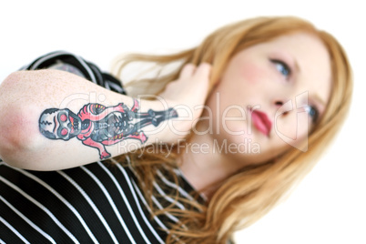 Strawberry Blonde Red Head Looking Into Distance with Tattoo Arm