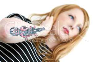 Strawberry Blonde Red Head Looking Into Distance with Tattoo Arm