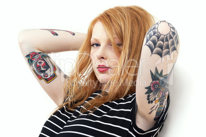 Strawberry Blonde Red Head Leaning Against Wall with Tattoo Arms