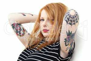 Strawberry Blonde Red Head Leaning Against Wall with Tattoo Arms