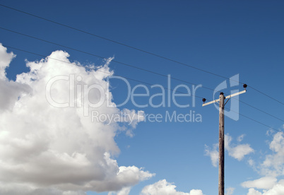 Electricity Pole on Blue Sky and Fluffy Clouds
