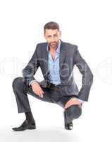 Portrait businessman sitting on his haunches