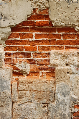 Old brick masonry with destroyed stucco